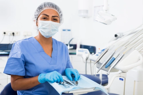 Dental Assistant School Student with mask smiling while handling dental instruments